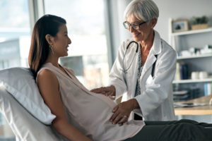 Doctor examining her pregnant patient