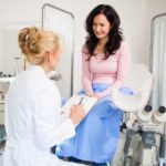 Woman smiling and talking to her gynecologist