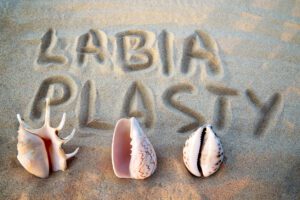 labiaplasty written on sand