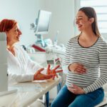 GYNECOLOGIST talking to pregnant woman