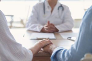 Mature couple holding hands at a fertility clinic