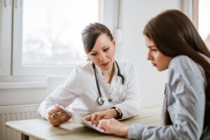 Charming female doctor giving advice to a female patient.