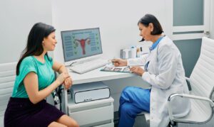 Doctor and woman patient is talking in gynecological office