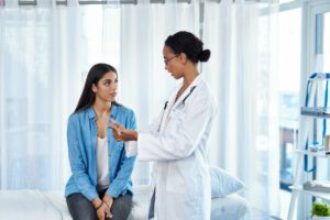 Women discussing with female doctor in clinic