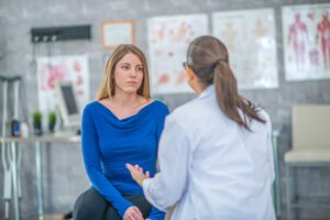 Doctor with woman patient discussing hormone therapy.